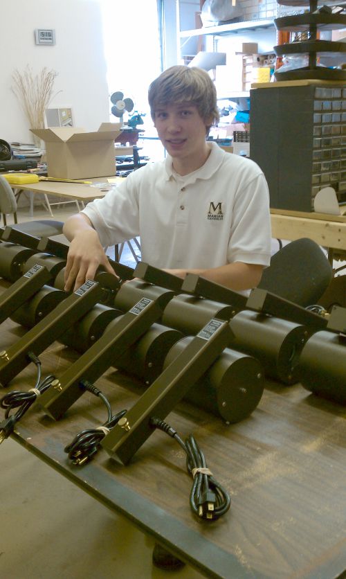 Chris assembling projectors on the assembly line